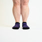 A model showcasing purple ankle socks