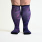 A person standing in purple compression socks