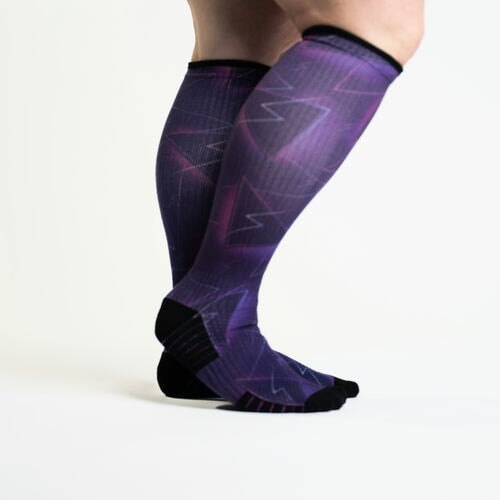 A person wearing purple compression socks