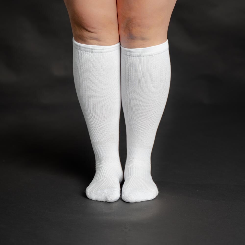 A person wearing white compression socks