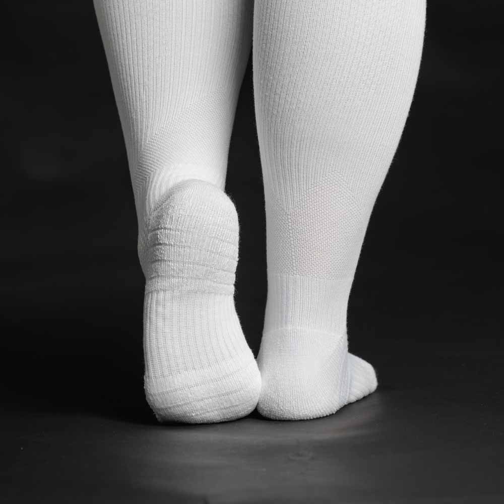 A person walking in white compression socks