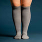 A person wearing gray compression socks