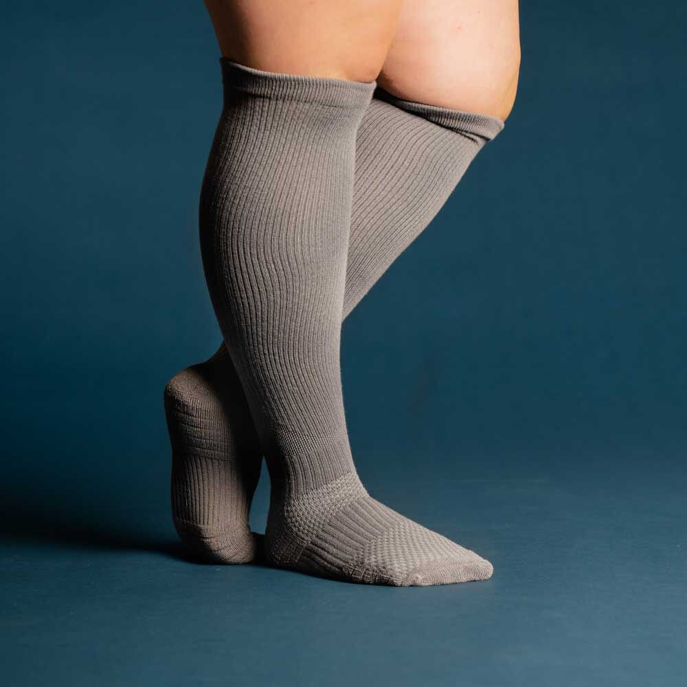 A model showcasing gray compression socks