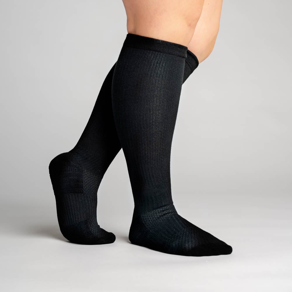 A person wearing black compression socks