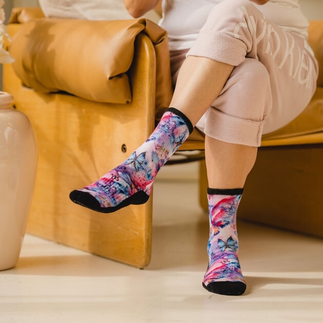 A person wearing crew butterfly diabetic socks