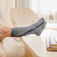 A model showcasing gray stretchy socks for elderly
