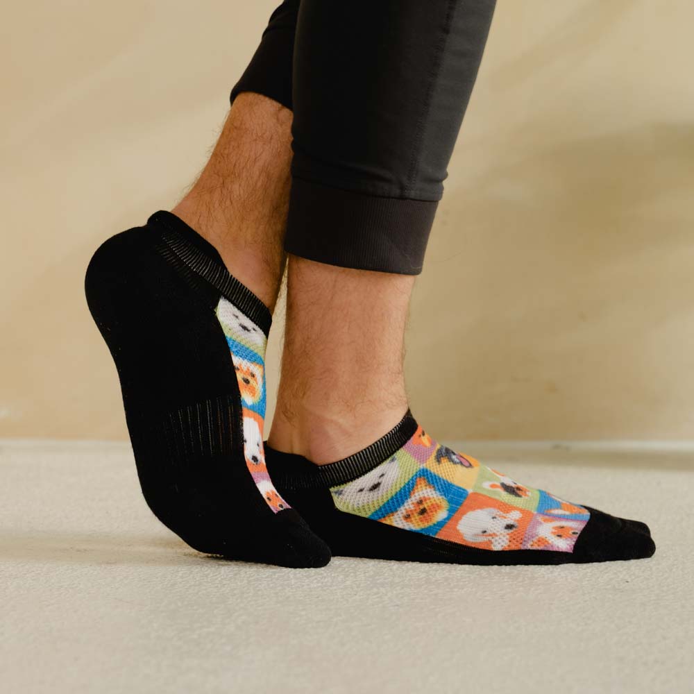 A person wearing dogs pattern ankle socks