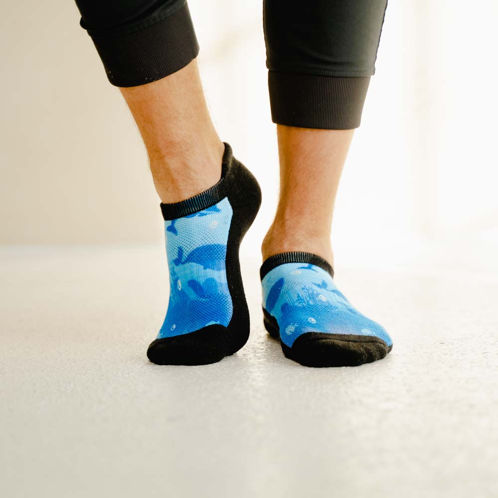 A person wearing deep sea pattern ankle socks