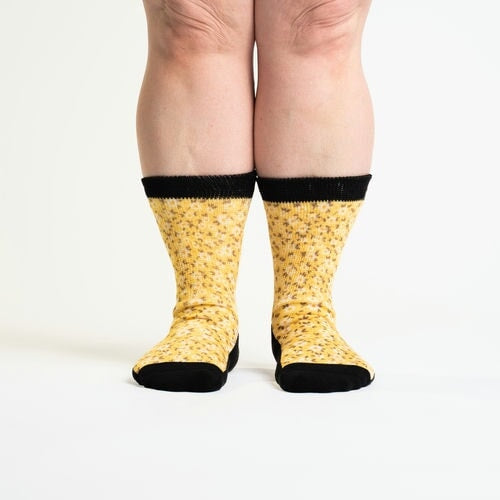 A person wearing crew yellow flower socks
