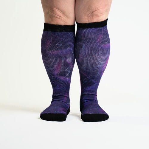 A person in knee-high purple socks