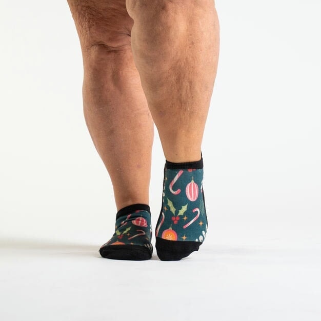 A person walking in ankle Christmas socks