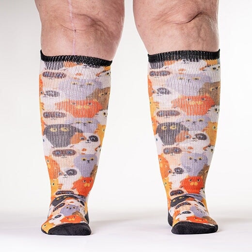 A person wearing cat print non-binding socks
