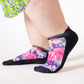 A person wearing floral ankle socks
