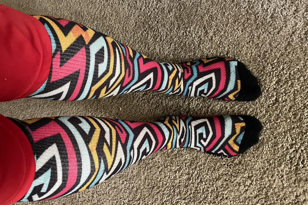 Legs of a lady wearing graffiti pattern compression socks