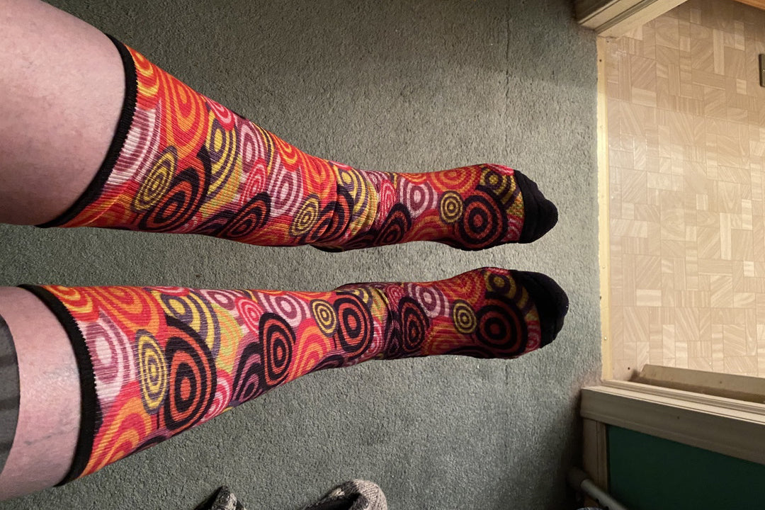 Legs of a lady with multicolor concentric pattern socks on