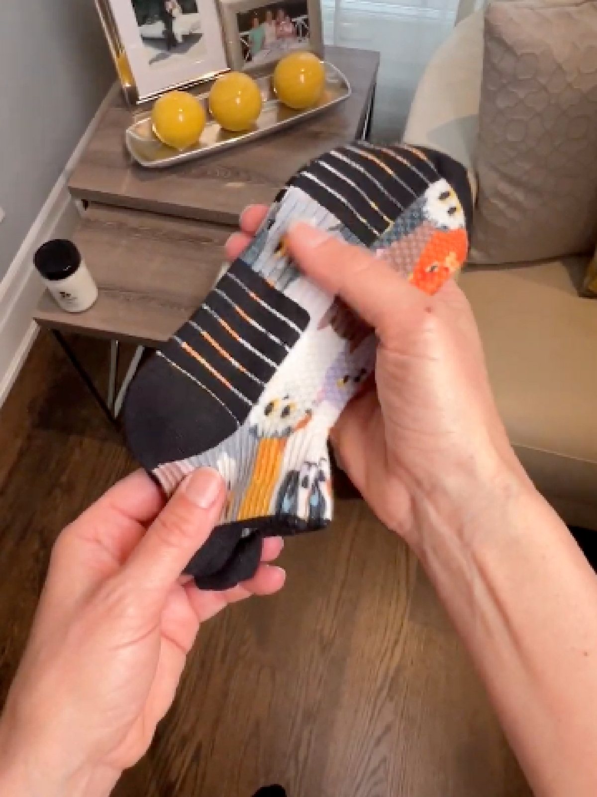 Hands showing a patterned Ankle Compression sock