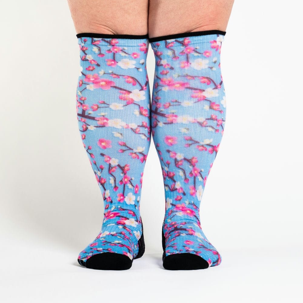 A person wearing cherry blossom compression socks