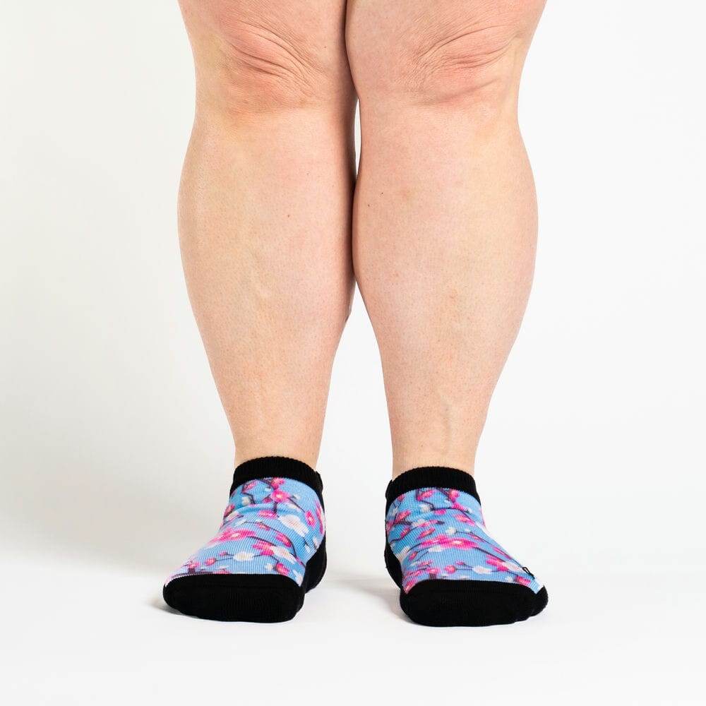 A person wearing flowery ankle socks