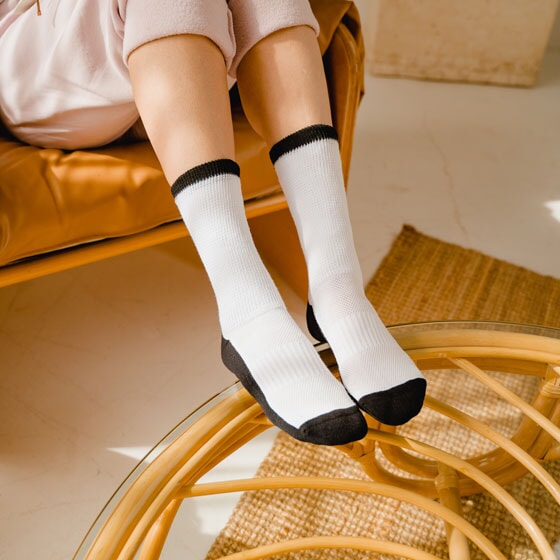 A person wearing black and white socks