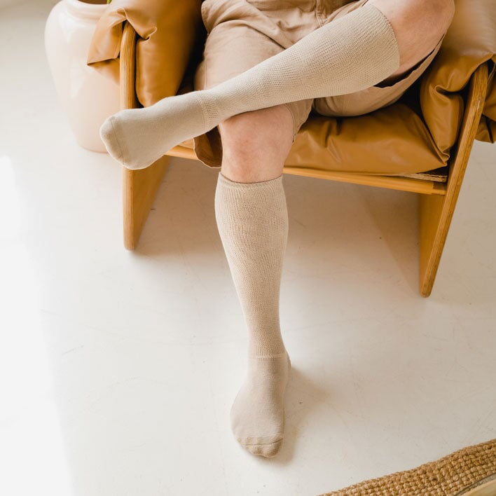 A person wearing tan color socks