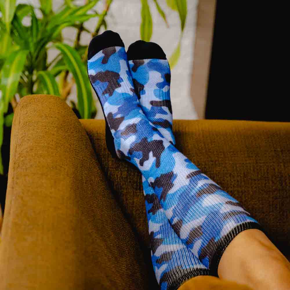 A person wearing blue camo non-binding socks