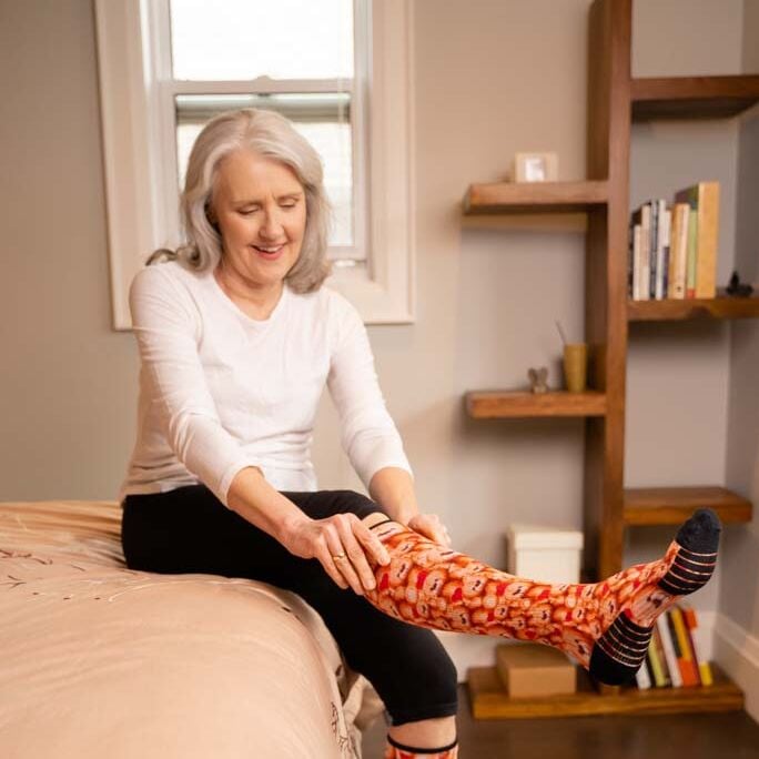 A woman wearing compression teddy socks