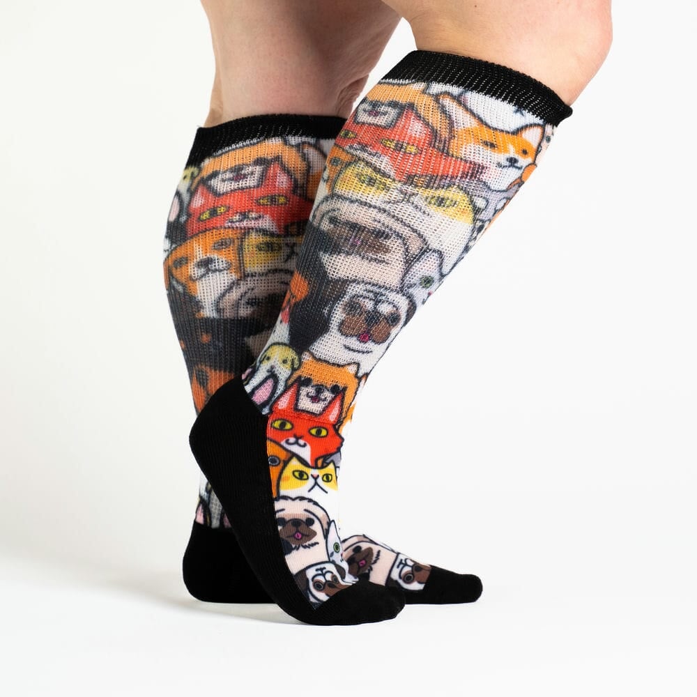 A person wearing cat & dog print socks