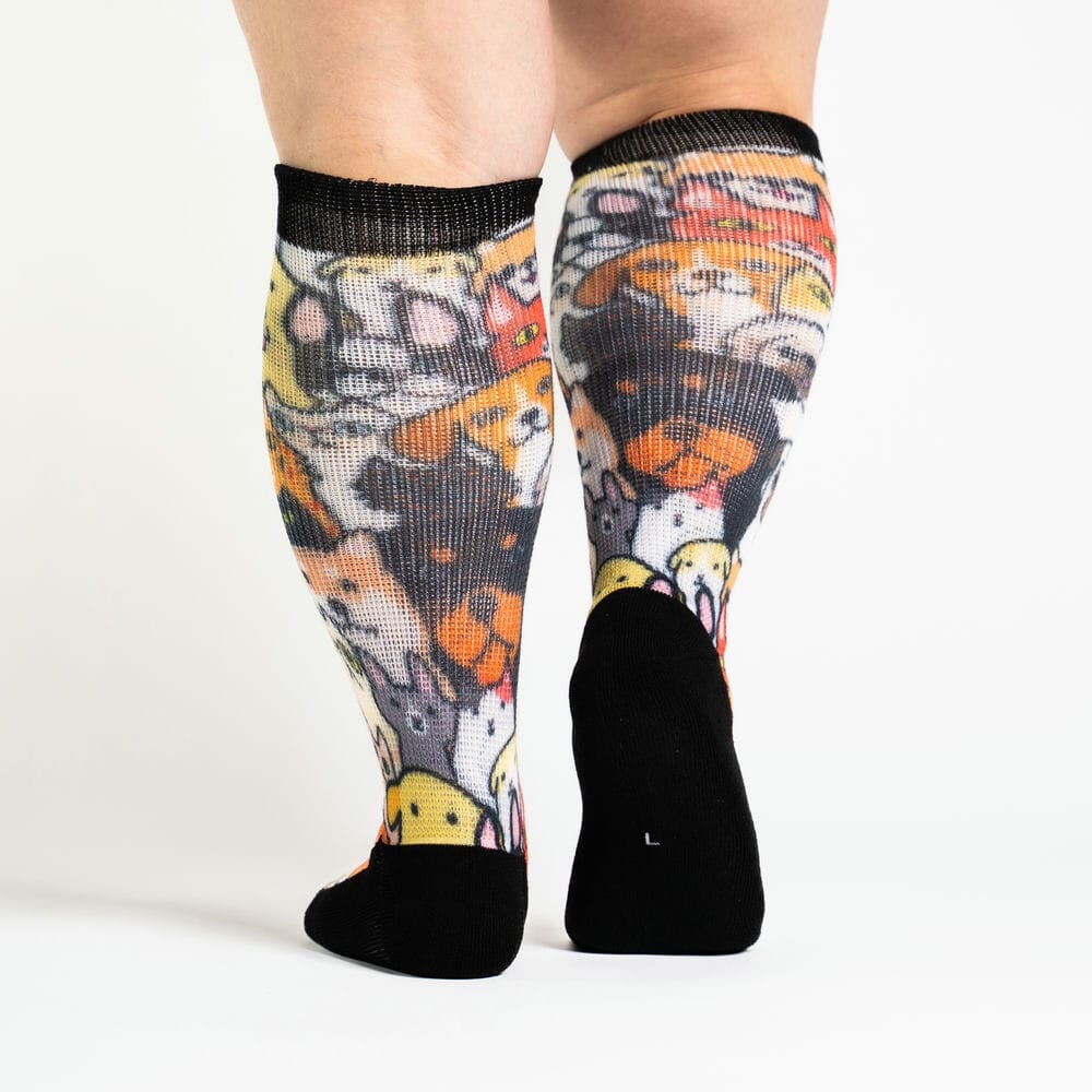 A person walking in cat & dog print socks