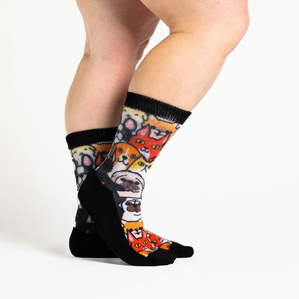 A person wearing crew cat & dog print socks