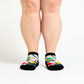 A person wearing toucan pattern ankle socks