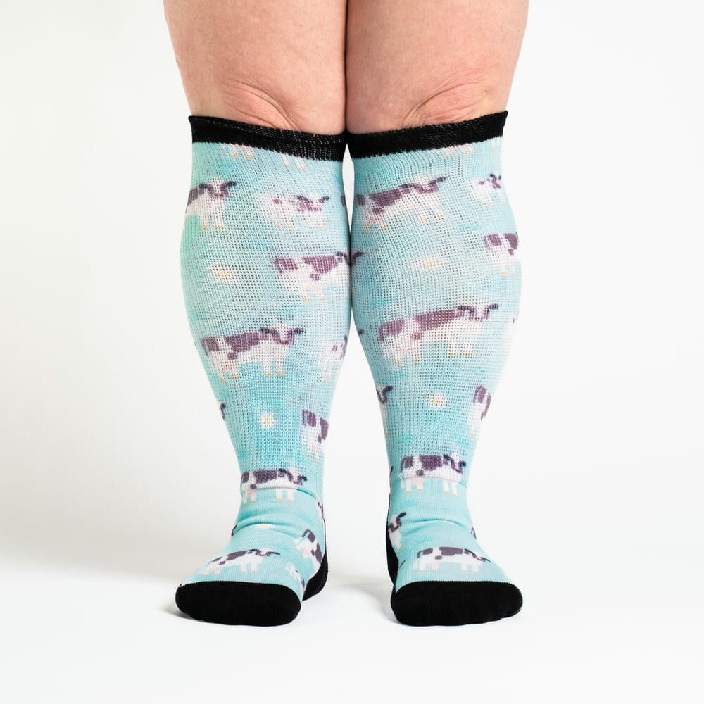 A person wearing cow socks