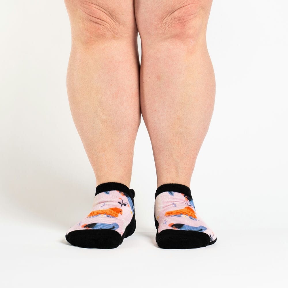 A person wearing ankle socks with chickens on them